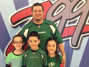 Matt Horejda (back) stands with his triplets (left to right) Courtney, Radek and Liesel Horejda at the annual Z99 radiothon at the Cornwall Centre in Regina on March 17, 2016.