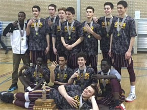 Members of the LeBoldus Golden Suns celebrate the team's unprecedented fourth consecutive Saskatchewan High Schools Athletic Association 5A boys championship on Saturday at Saskatchewan Polytechnic in Moose Jaw.