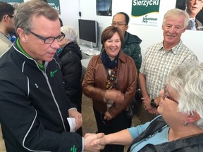 Saskatchewan Party leader Brad Wall shakes the hand of supporter Judy Bergsveinson at a campaign stop in La Ronge on Monday, as Donna and Brook Ede look on. (EMMA GRANEY PHOTO)