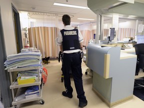 A paramedic transports a patient into the Regina General Hospital ER.