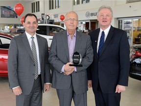 Jerry Daniel, from left, General Motors general director Sales, Bruce Axelson, CEO of Capital Automotive Group, and Glenn Lemmerick stand in the showroom of Capital GMC in Regina on Wednesday. Capital GMC Buick Cadillac was named  the number one new and used GM dealer in Canada for 2015  by General Motors Canada Ltd.