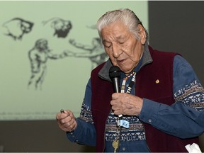 Elder John Stonechild speaks during the Cultural Protocol Symposium at the Performing Arts Centre in Regina.