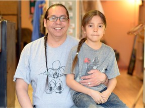 Lorne Kequahtooway , left, and his 7-year-old son Sunkatogeja Big Eagle Kequahtooway proudly display their braids.