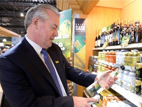 Minister responsible for SLGA Don McMorris looks over product at the South Albert Liquor store in Regina on April 23, 2015.