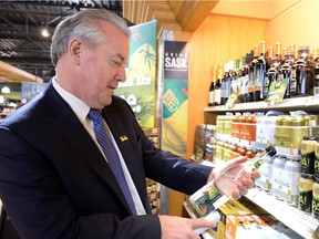Minister responsible for SLGA Don McMorris looks over product at the South Albert liquor store in Regina on April 23, 2015.