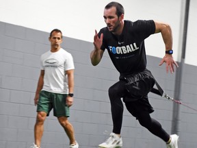 Dan Farthing, left, works with former Saskatchewan Roughriders receiver Weston Dressler — now a member of the Winnipeg Blue Bombers — during a session earlier this year at the Level 10 Performance Compound.