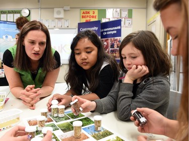 Sara Shymk of Agriculture in the Classroom talks with Allyson Atendido, Ada Dechene and Zanna Martin all students at Connaught Community School as part of a hands-on activity with the Agriculture in the Classroom program.