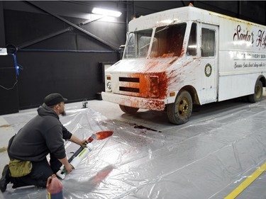 Second assistant special effects person Joel Alton performing blood effects on a Santa's Helpers van at the Soundstage in Regina.