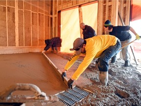 A work crew from Brason Construction pours a garage floor in a two-storey house in the Creeks subdivision in Regina. Housing starts nearly doubled in February over last year.