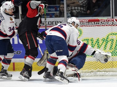 Chase Harrison and net-minder Jordan Hollett with the Regina Pats can't stop the Moose Jaw Warriors from scoring during WHL hockey action at the Brandt Centre in Regina on March 11, 2016.