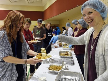 Katie Rosenkranz (L) and server Danielle Park both teachers at F.W. Johnson Collegiate show there was no shortage of food during Diversity Day celebrating the International Day for the Elimination of Racism on March 21, 2016.