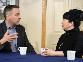 NDP Leader Cam Broten (L) talks with seniors care advocate Carrie Klassen (R) during a campaign stop in the home of a supporter in Regina on March 22, 2016.  Britain pledged to hire 400 more front-line senior care workers.