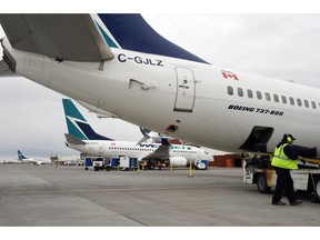 WestJet planes sit on the tarmac at Regina International Airport on Wednesday. WestJet confirmed that six flights were cancelled on Tuesday night and Wednesday morning due to volcanic ash from the Pavlof Volcano in Alaska, which erupted with a 11,000-metre plume on Sunday.