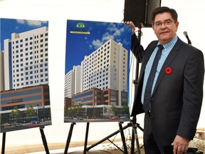 Namerind president and CEO Robert Byers beside design renderings for their planned mix-use head office building that is to be built in downtown Regina in November 2015.