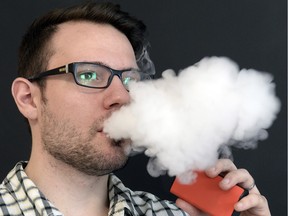 Brett Bostick, co-owner of Vaping the Way, demonstrates an e-cigarette.