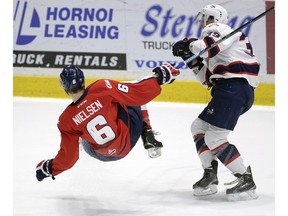 Andrew Nielsen of the Lethbridge Hurricanes is knocked down by Lane Zablocki of the Regina Pats during WHL playoff action at the Brandt Centre on Tuesday.