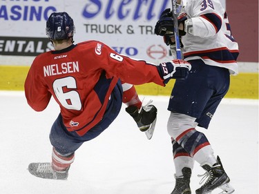 Hurricane's Andrew Neilson is dumped by Pats' Lane Zablocki during game three of WHL playoff action between the Lethbridge Hurricanes and the Regina Pats at the Brandt Centre in Regina Tuesday night.