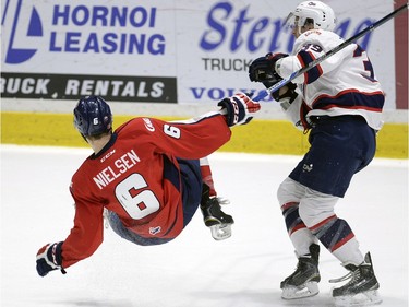 Hurricane's Andrew Neilson is dumped by Regina Pats' Lane Zablocki during game three of WHL playoff action between the Lethbridge Hurricanes and the Regina Pats at the Brandt Centre in Regina Tuesday night.