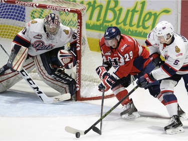 Hurricane's Ben Duperreault swings around on Pats' goaltender Tyler brown while being tied up by Pats Chase Harrison during game three of WHL playoff action between the Lethbridge Hurricanes and the Regina Pats at the Brandt Centre in Regina Tuesday night.