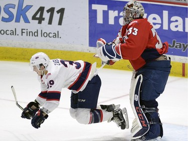 Hurricanes goal tender Jayden Sittler takes out Pats Lane Zablocki during game four of WHL playoff action between the Lethbridge Hurricanes and the Regina Pats at the Brandt Centre in Regina Wednesday night.
