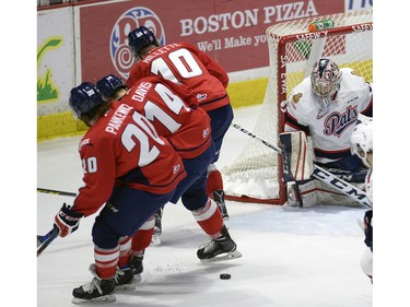 Hurricanes Kord Pankewicz20, Brett Davis14, and Cory Millette 10 miss the puck in front of Pats goal tend Tyler Brown during game four of WHL playoff action between the Lethbridge Hurricanes and the Regina Pats at the Brandt Centre in Regina Wednesday night.