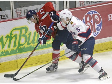 Pats colby Williams checks Hurricanes Colton Kroeker during game four of WHL playoff action between the Lethbridge Hurricanes and the Regina Pats at the Brandt Centre in Regina Wednesday night.