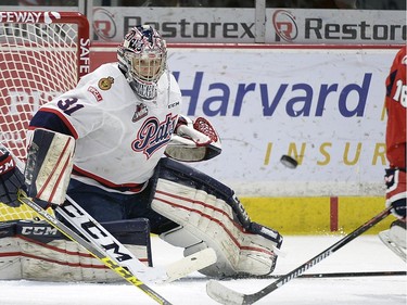 Pats goal tender Tyler Brown keeps a keen eye on the puck as Hurricanes Ryley Lindgren moves in during game four of WHL playoff action between the Lethbridge Hurricanes and the Regina Pats at the Brandt Centre in Regina Wednesday night.