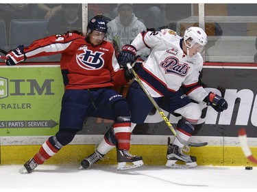Pats Rob Holmes ties up Hurricanes Drayton Thunder Chief during game four of WHL playoff action between the Lethbridge Hurricanes and the Regina Pats at the Brandt Centre in Regina Wednesday night.