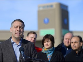 Saskatchewan NDP leader Cam Broten, left, flanked by other party candidates, speaks near the EMS Central Operations building at 1300 block Albert St. in Regina on Saturday.