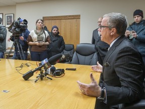 Premier Brad Wall tells reporters gathered at the Saskatoon Cabinet Office that he opposes a national carbon tax .