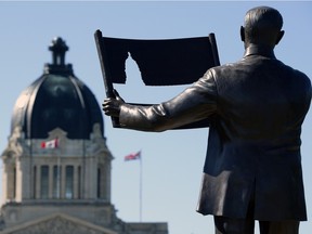 A statue of Saskatchewan's first premier, Walter Scott, with plans for the Legislative Building.