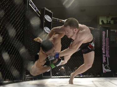 Sean Quinn, right, and Chris Day both grapple to the canvas during the Queen City Coronation, an MMA event held at the Orr Centre in Regina on Saturday March 12, 2016.