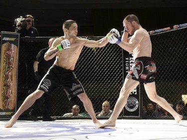 Sean Quinn, right, handles Chris Day's attack during the Queen City Coronation, an MMA event held at the Orr Centre in Regina on Saturday March 12, 2016.