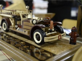 A 1927 Ahrens-Fox firetruck sits on display the Woodworking Show and Sale held at the Tartan Curling Club in Regina, Sask. on Sunday April. 24, 2016. Southern Saskatchewan Woodturners Guild member Lloyd Dyer (not pictured) used 23 different varieties of wood and no paint to make the truck.