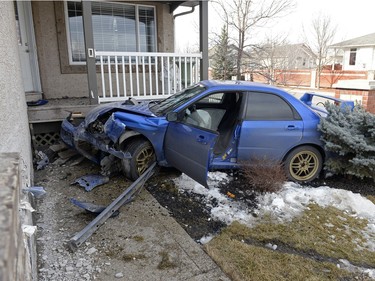 A car rests on the front step of a home in the Wascana View neighbourhood after it left the street and slammed into the side of the garage in Regina on Saturday March 26, 2016.