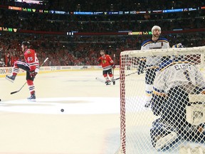 Chicago Blackhawks right wing Andrew Shaw, left, reacts after scoring in the third period against St. Louis Blues goaltender Brian Elliott during Game 6 of an NHL playoff series at the United Center on Saturday.