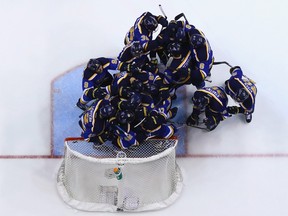 Members of the St. Louis Blues celebrate after beating the Chicago Blackhawks in Game 7 of a Western Conference first-round playoff series Monday.