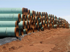 Kilometres of pipe ready to become part of the Keystone Pipeline are stacked in a field near Ripley, Okla.