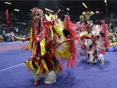 Leonidas Mossehunter, left, participates in an initiation dance at the FNUC Pow-wow held at the Brandt Centre in Regina on Saturday April 2, 2016.