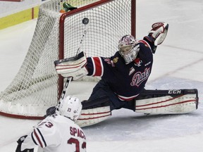 Regina Pats goaltender Tyler Brown stops Michael Spacek of the Red Deer Rebels on Friday night during Game 5 of their second-round WHL playoff series at the Centrium in Red Deer.