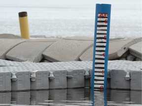 A post indicates the level of water at the Regina Beach Yacht Club in Regina Beach, Sask. on Sunday May 4, 2014. The top red mark indicates the level during the 2011 flood.