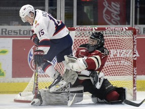 Regina Pats forward Sean Richards jumps across Red Deer Rebels goalie Rylan Toth during the first period of a WHL playoff game at the Brandt Centre on Sunday.