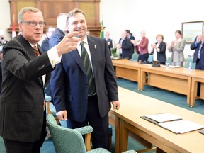 Premier Brad Wall greets a room packed with Saskatchewan Party MLAs at their first post-election caucus meeting on Wednesday.