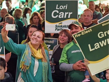 Larissa Steinley  (L) wife of Sask Party candidate Warren Steinley takes a selfie at a Saskatchewan Party rally at the Queensbury (Salon A) in Regina.