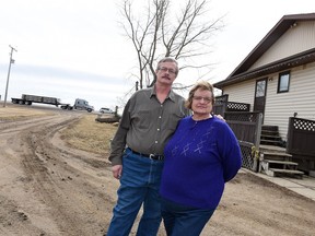 Roch and Bonnie Poissant beside their home west of Regina. The Poissants' home needs to be moved as a result of the Regina bypass project.