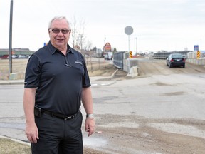 Wine Kitz owner Dave Carvell by the Eastgate Drive temporary bridge over Pilot Butte Creek. Carvell is one business owner pushing for a better solution to access businesses in his area from Coleman Crescent. That solution was presented by the city at an open house on April 12, 2016.