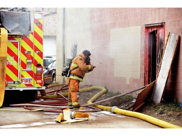 Firefighters try to manage a fire inside Wilf's Autobody & Painting on Tuesday afternoon.