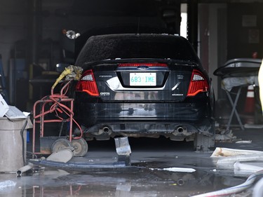 A car sits inside Wilf's Autobody as members of Regina Fire and Protective Services tried to deal with flames.