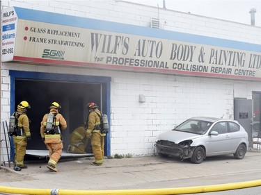 Firefighters fighting a fire at Wilf's Autobody & Painting Ltd. on the 1600 block of St. John Street on Tuesday afternoon.