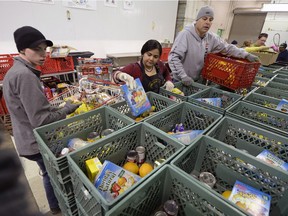 Volunteers work at the Regina Food Bank in Regina ahead its annual 12 Days of Christmas Campaign.